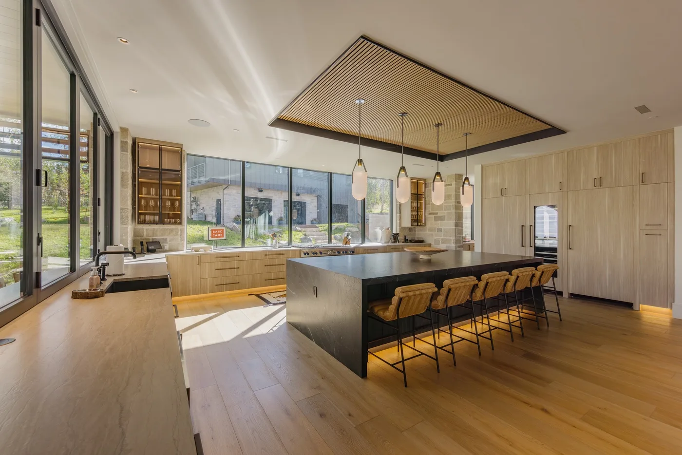 A spacious kitchen with a large island, bar seating, and windows along one side.