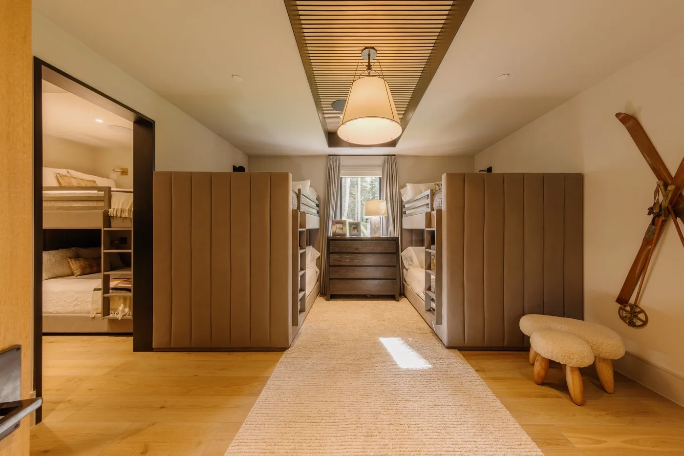 A warm bedroom with built-in storage, a bed, and a woven rug.