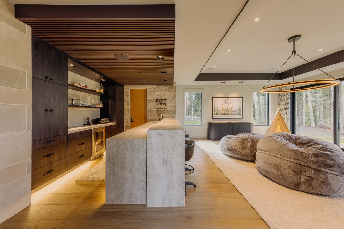 Open-plan living area with a kitchen, a dining island, and a large lounge space.