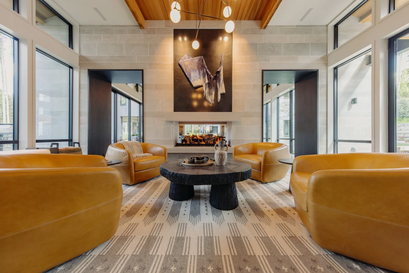 A bright lounge with leather seating arranged around a low central table.