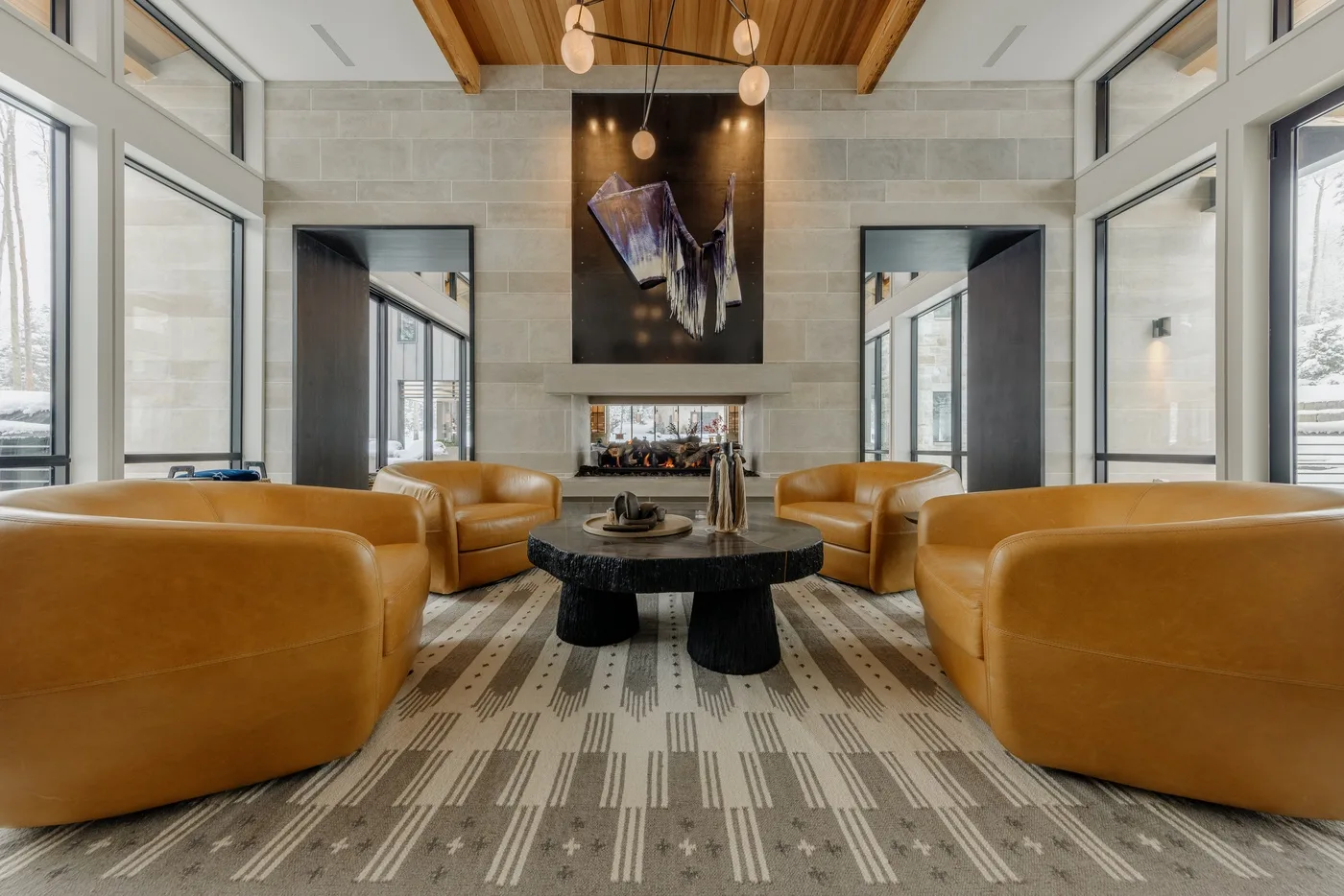 A bright lounge with tan seating arranged around a low coffee table.