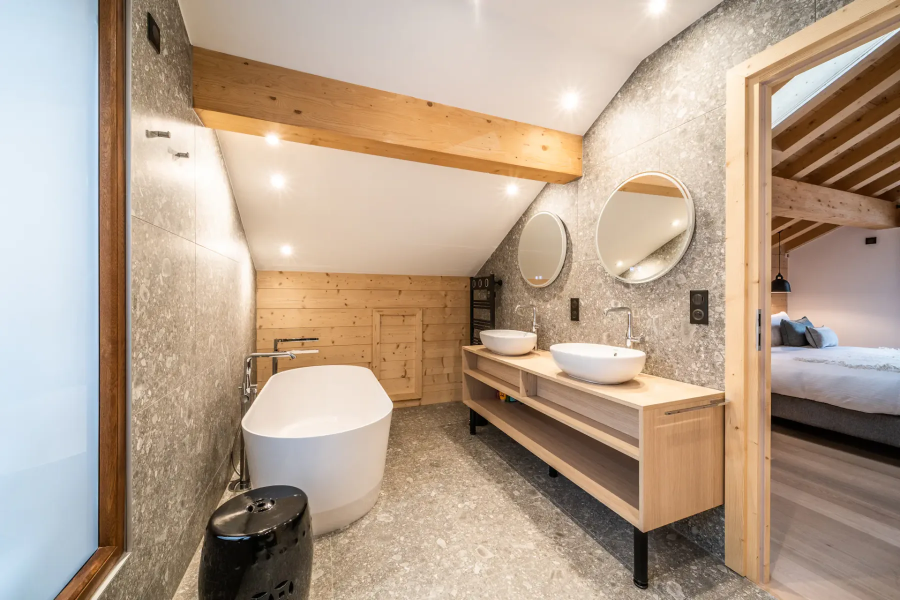 A bathroom with a freestanding bathtub and a double-sink vanity.