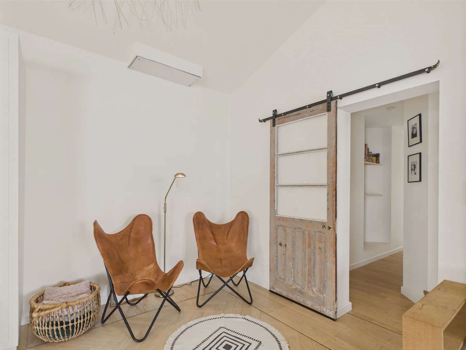 A bright sitting area with two folding seats beside a sliding door.