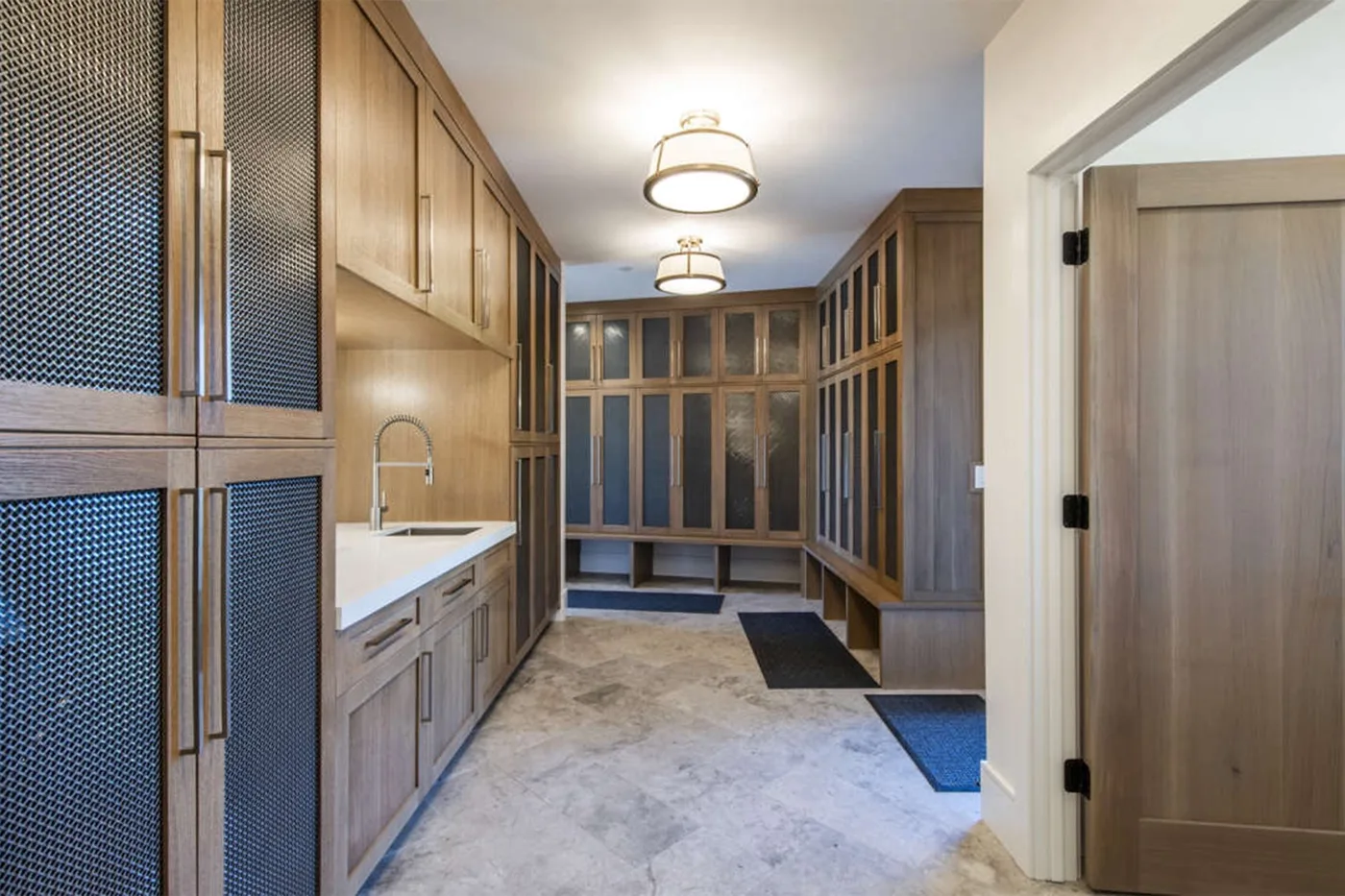 A wood-paneled dressing room with built-in cabinets and a countertop sink.