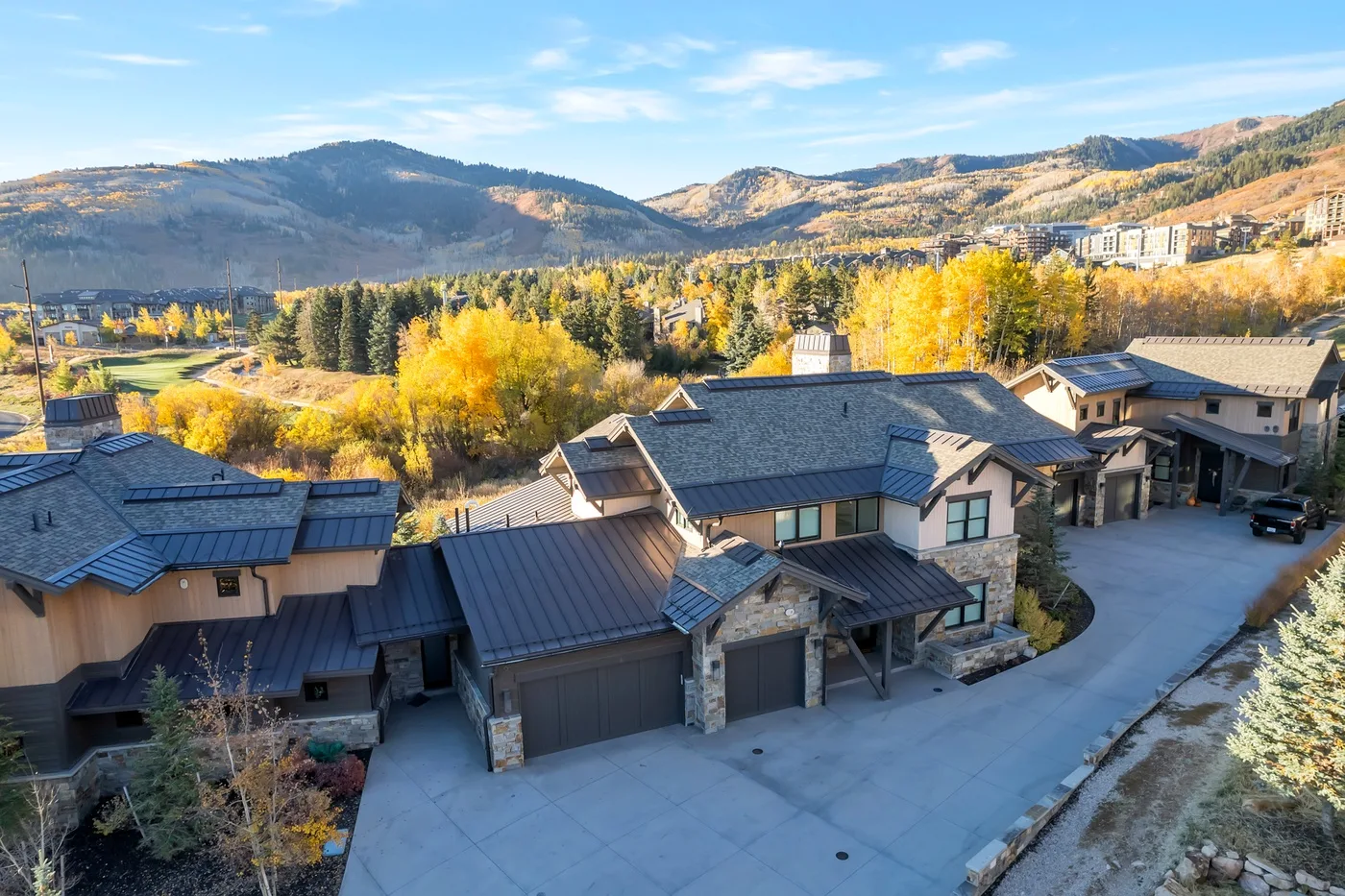 A cluster of mountain homes overlooks a tree-filled valley.