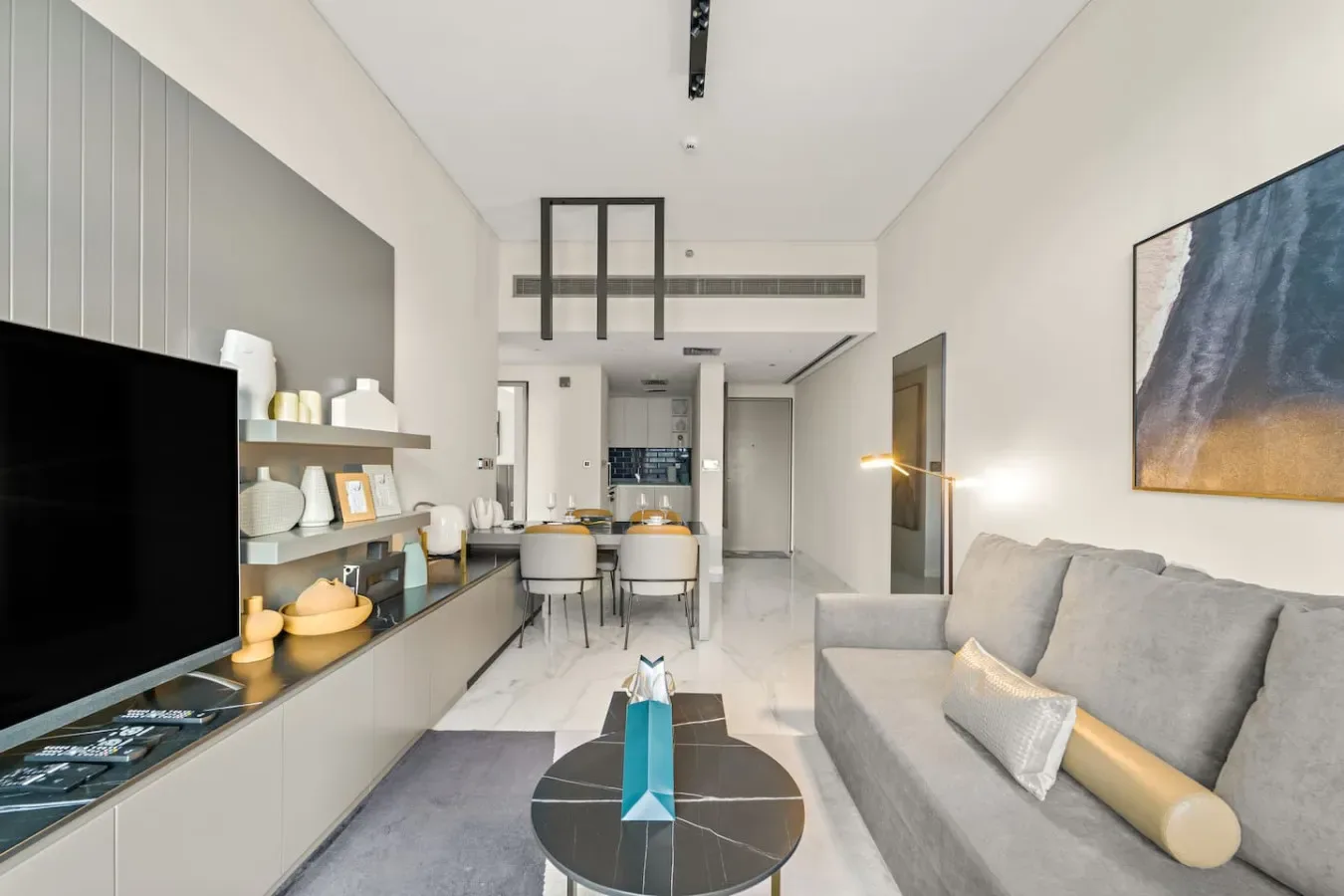 A modern living room with a dining table and seating.