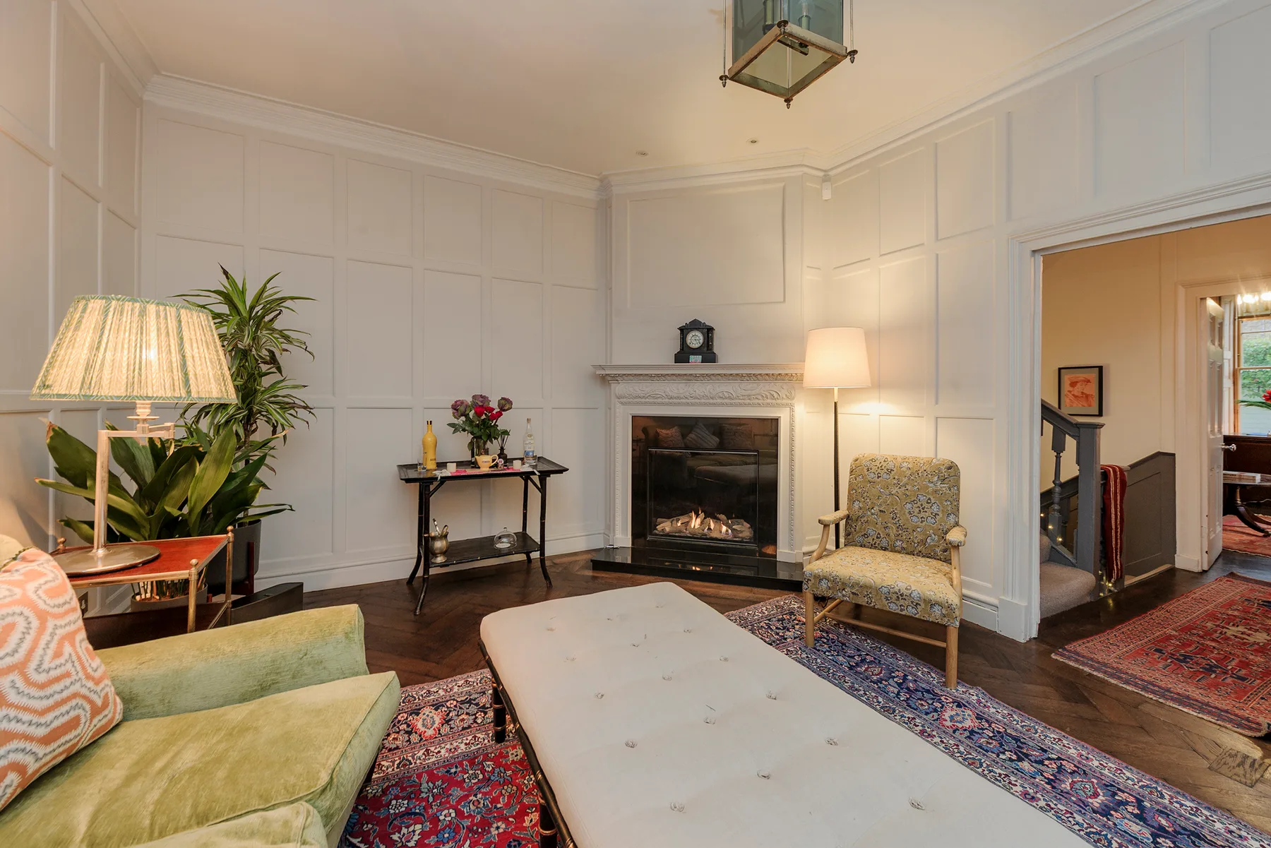 A living room with a fireplace, seating, and a large coffee table.