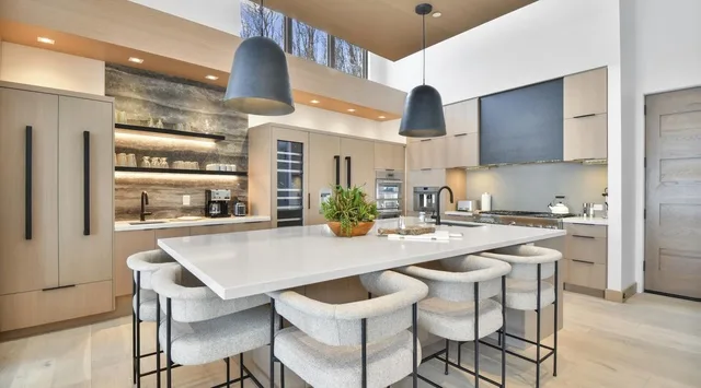 A modern kitchen with a large island and seating.