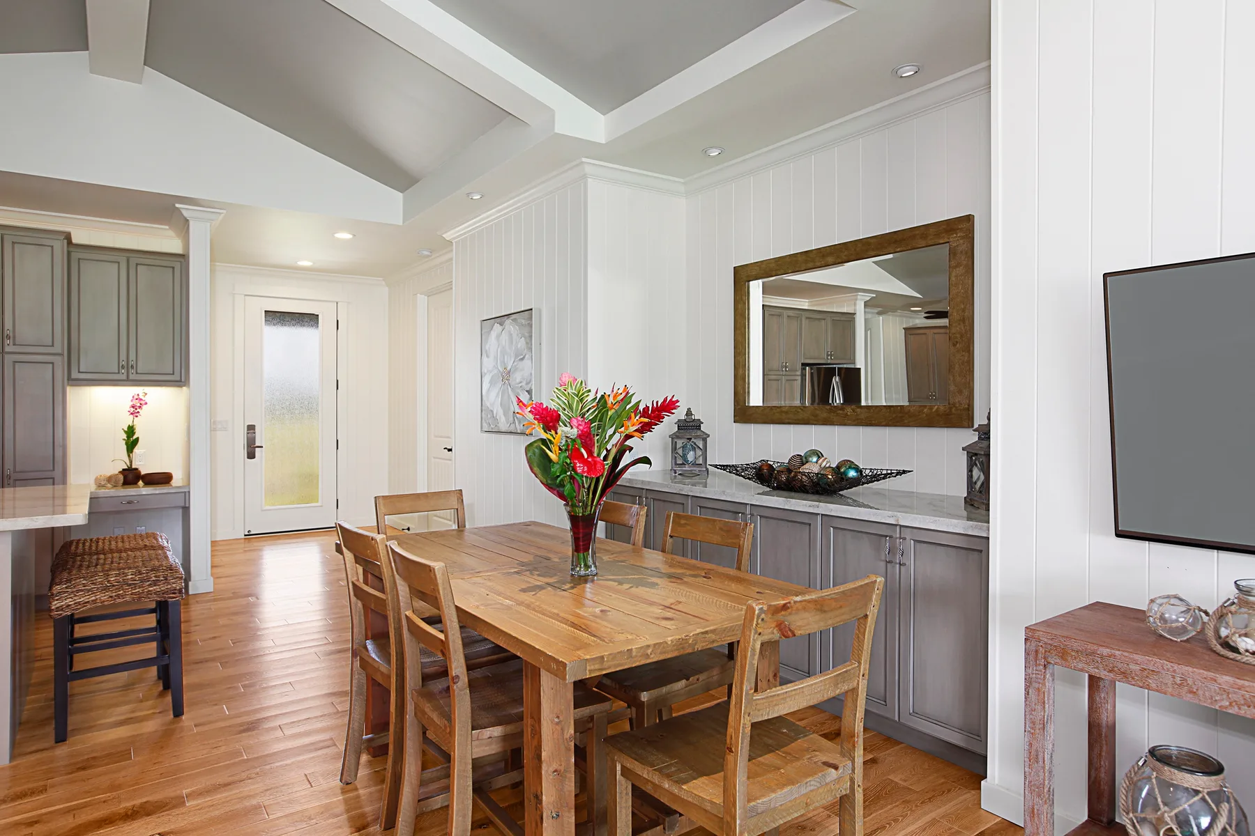 Comedor con una mesa de madera y sillas junto a una encimera de cocina.