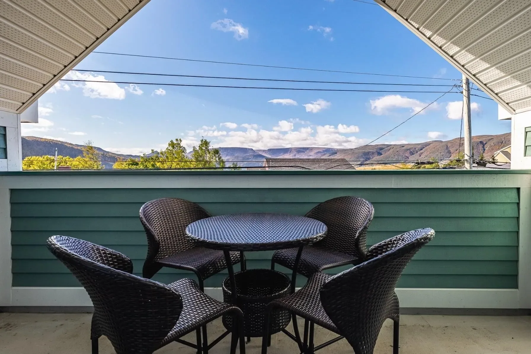 Balcony with table and chairs overlooking mountains