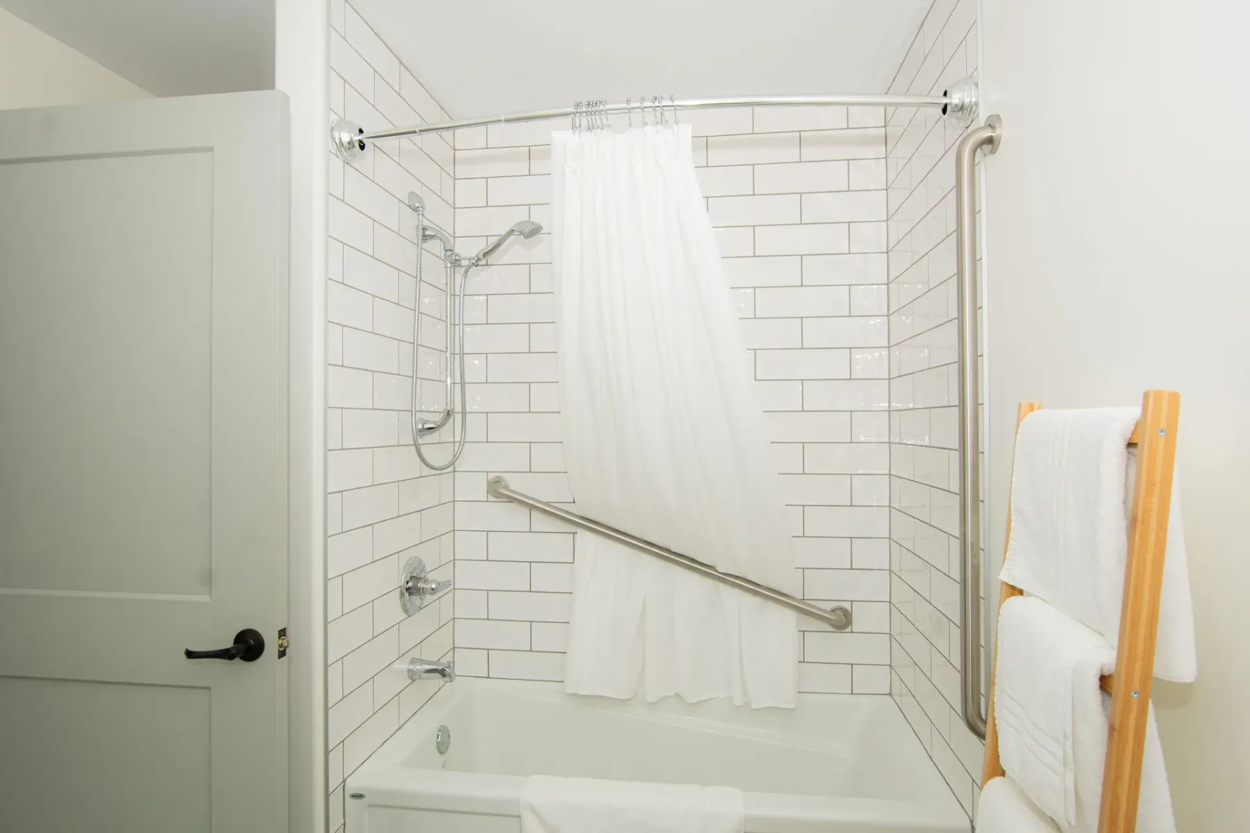 Bathroom with bathtub, shower, and towel rack