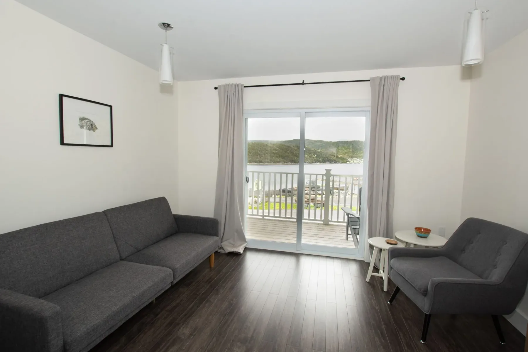 Sitting area with couch and chairs beside a sliding glass door