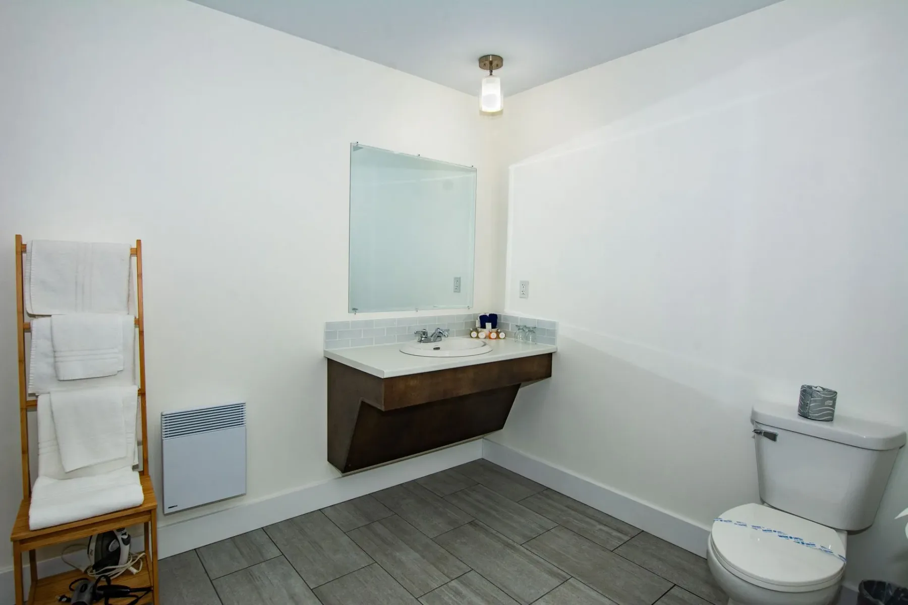 Bathroom with sink, toilet, and mirror