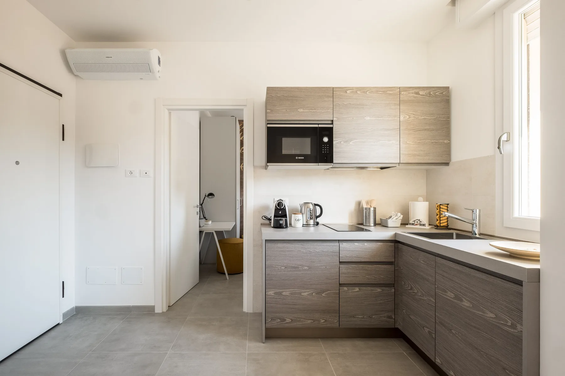 A bright kitchen with wood-toned cabinets and a countertop.