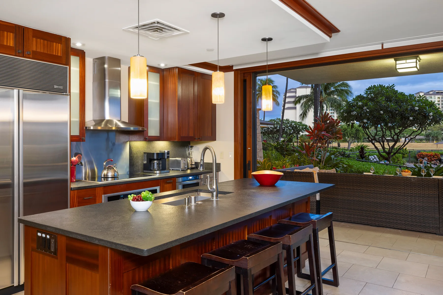 Una cocina moderna con una amplia isla y una gran ventana con vistas a la vegetación.