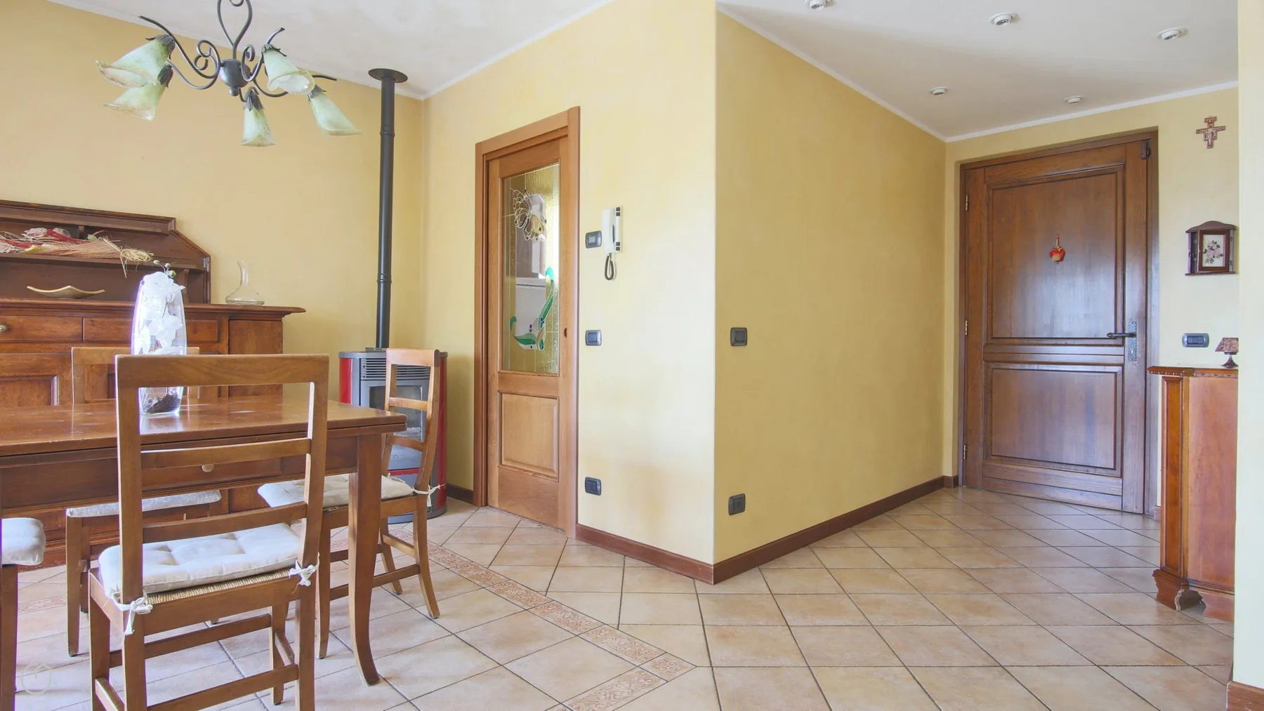 A dining area with wooden seating and a wooden cabinet.