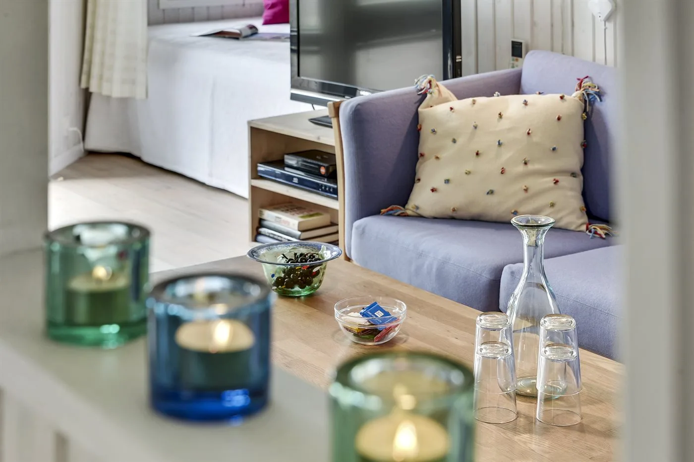 A living area with seating, a television, and a wooden coffee table.