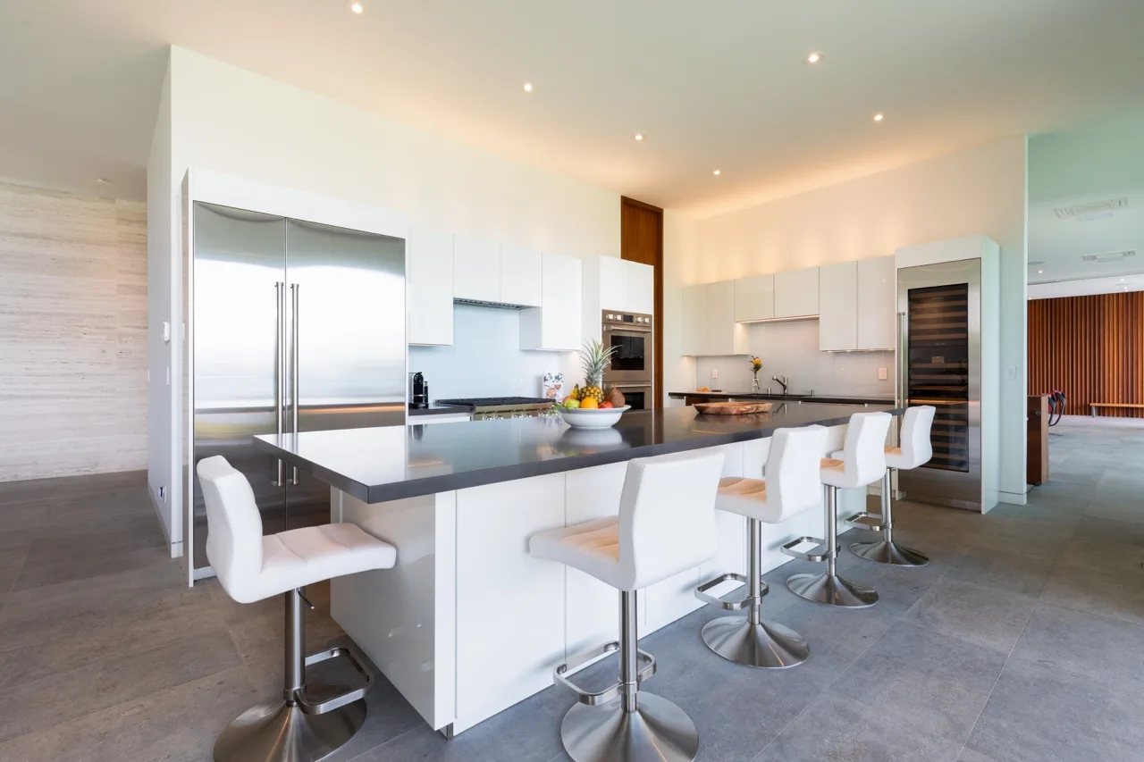 A modern kitchen with a large island and bar seating.