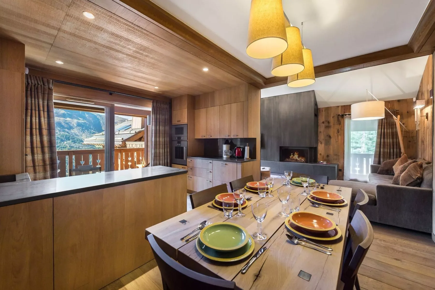Open-plan dining and living area with a set table beside the kitchen.