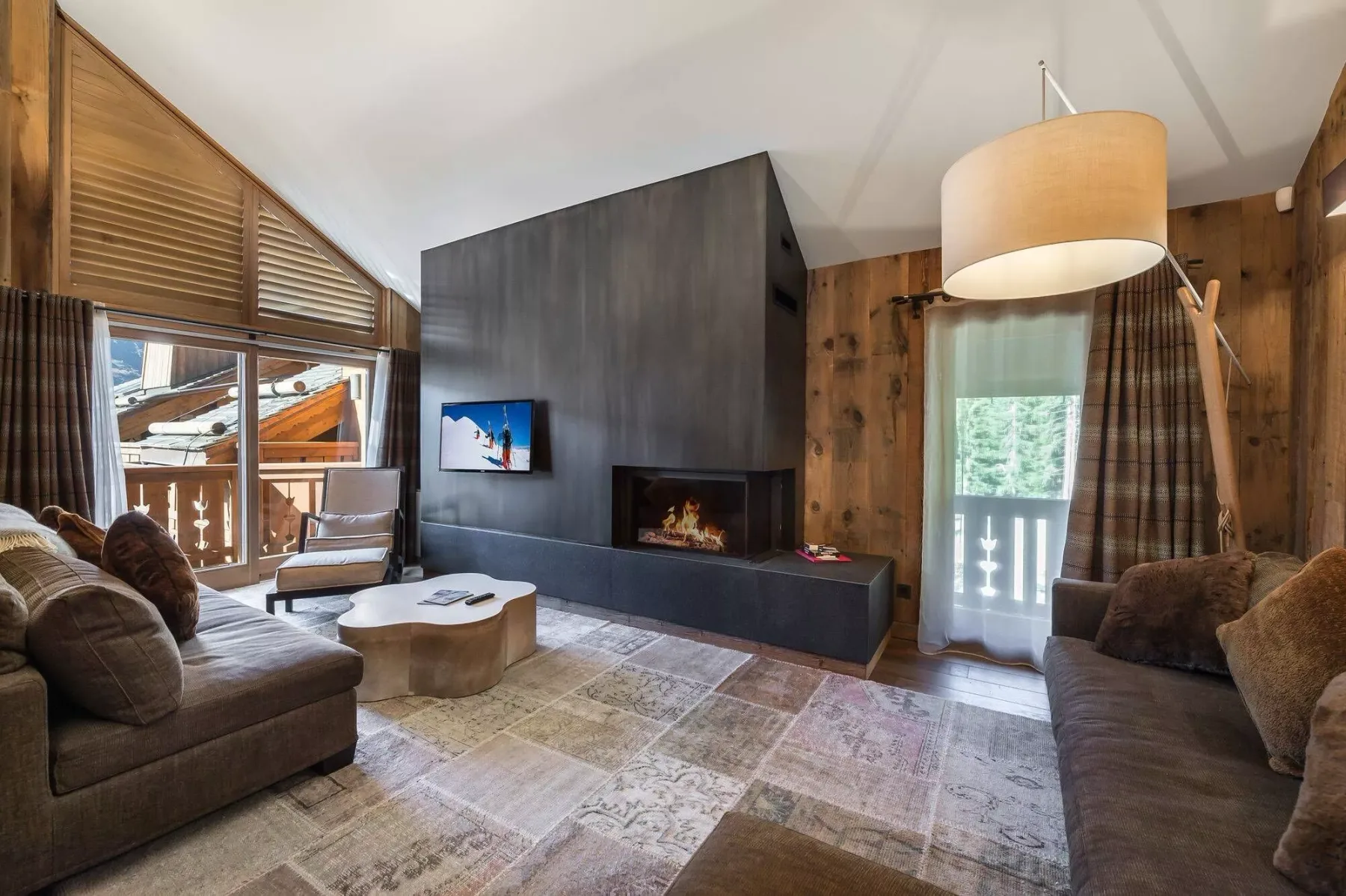 A living room with seating, a coffee table, and a fireplace.