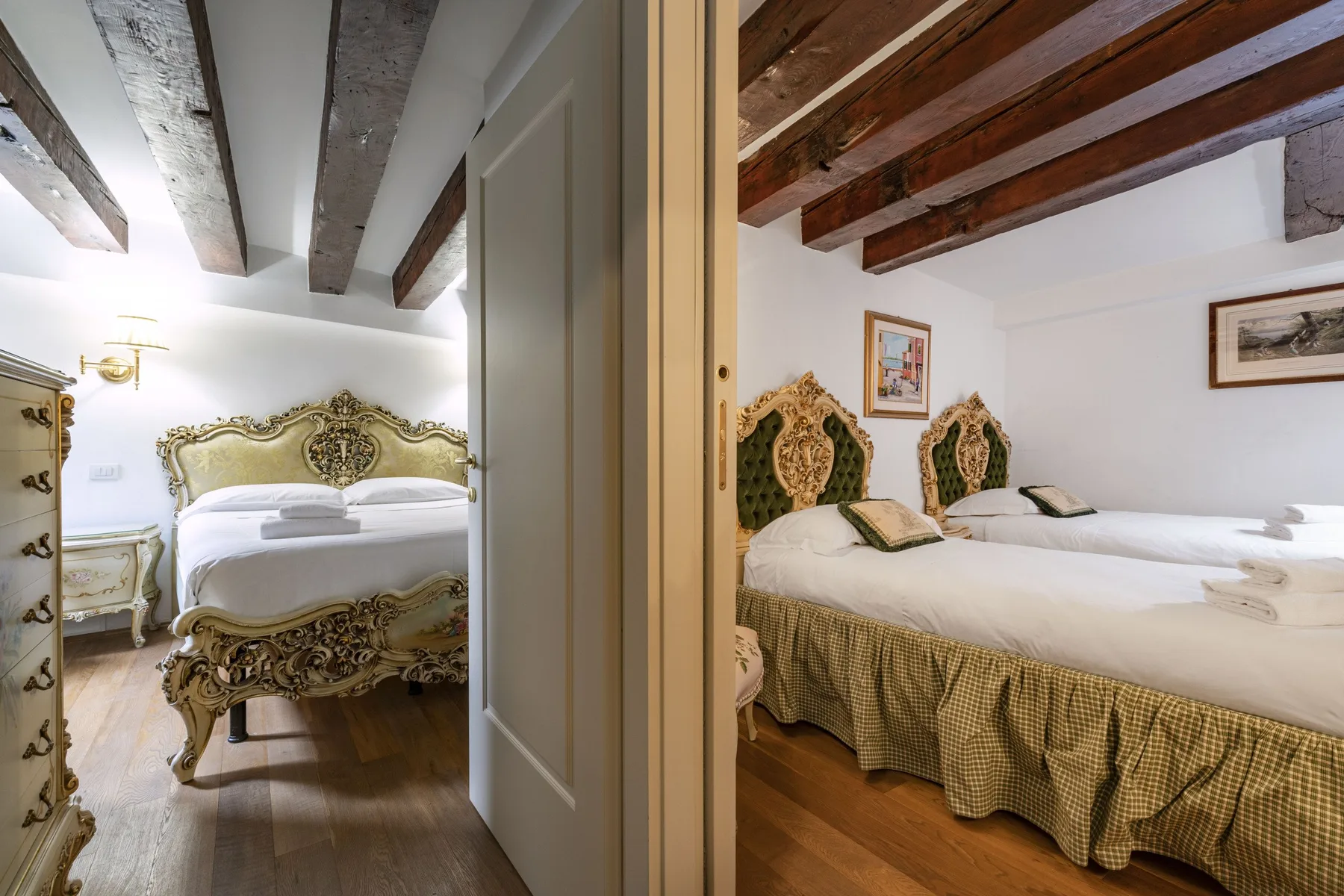 Two bedroom views show ornate beds beneath exposed ceiling beams.