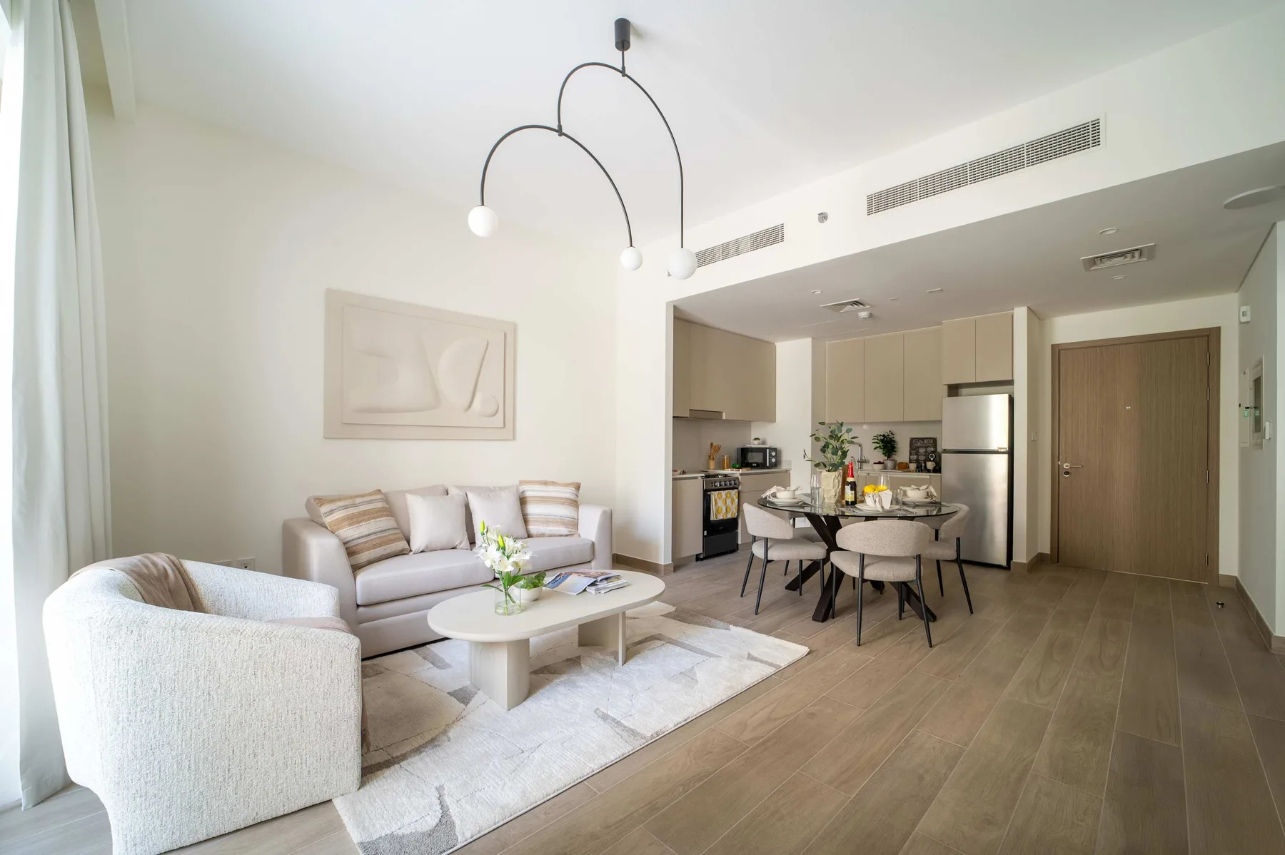 Una sala luminosa se conecta con el comedor y la cocina.