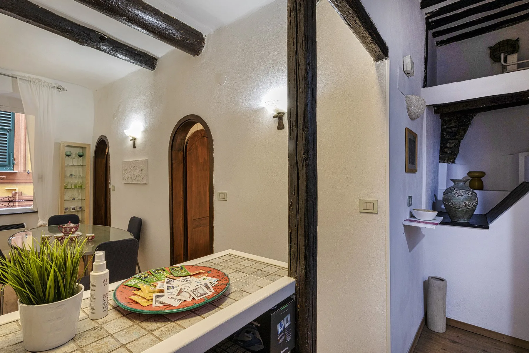 An interior dining area with a tiled counter and a round serving tray.