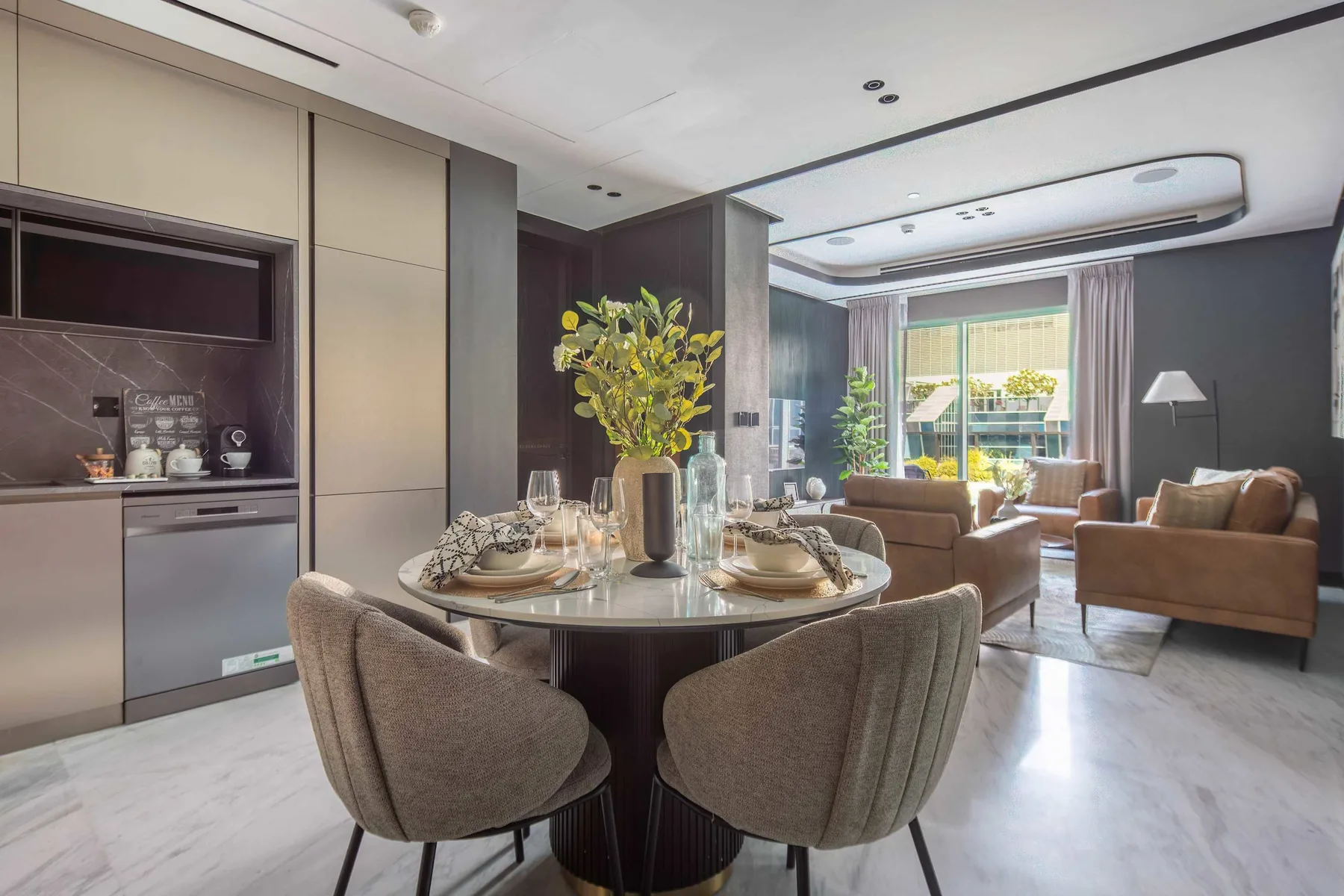 An open-plan dining and living area with a round table and seating.