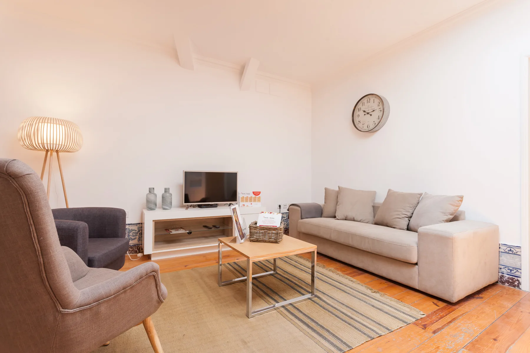 Living room with seating, a coffee table, and a television.