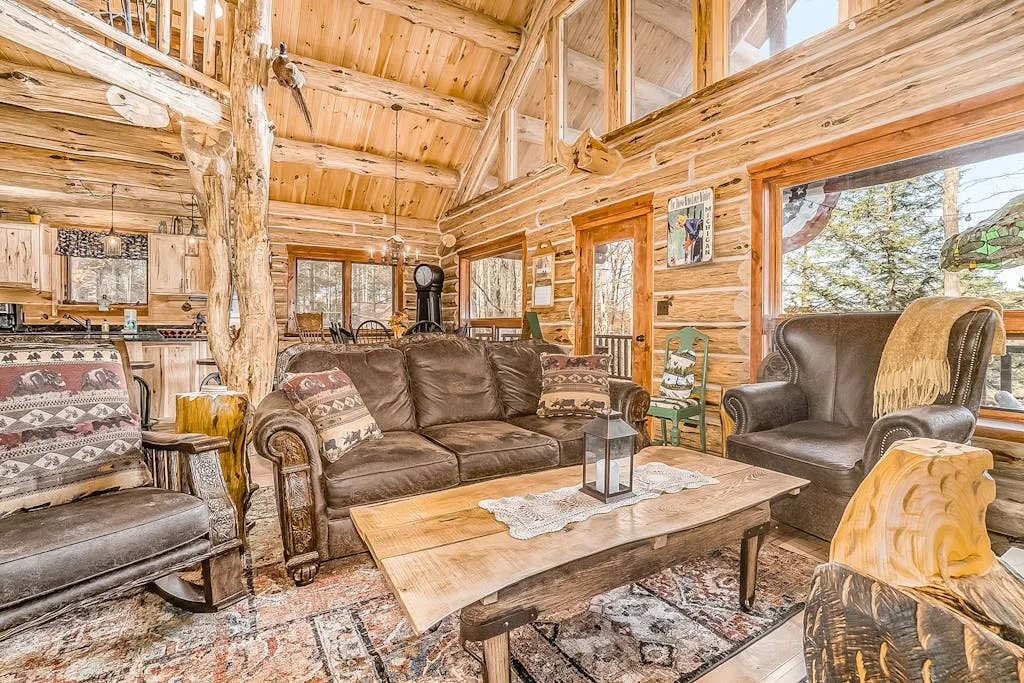 A wood-paneled living room has seating arranged around a low coffee table.