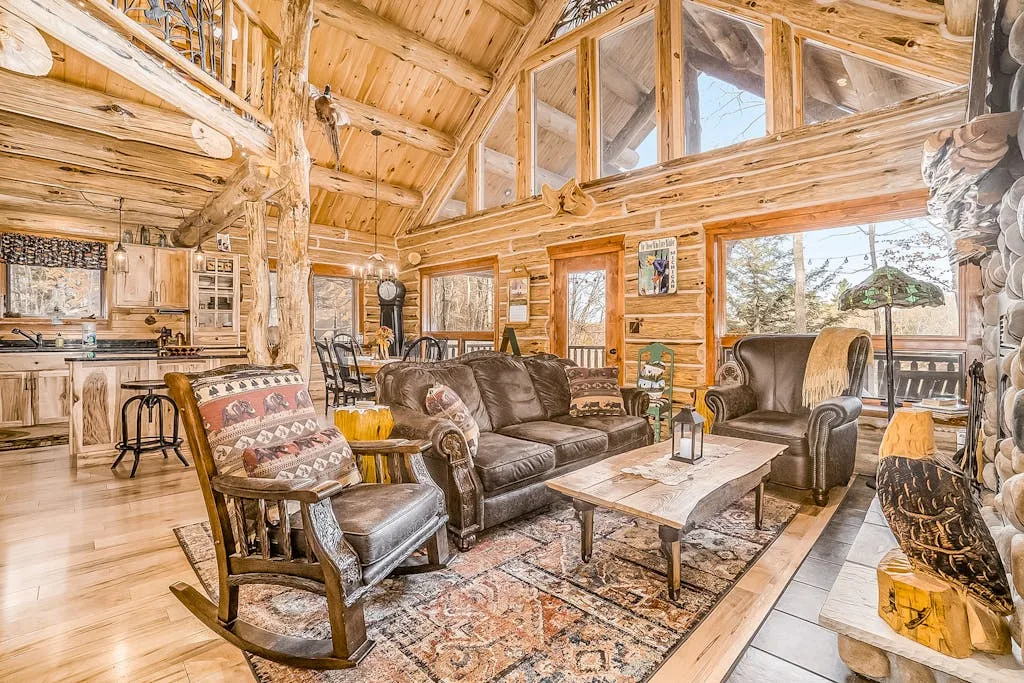 A rustic living room with leather seating and a wooden coffee table.