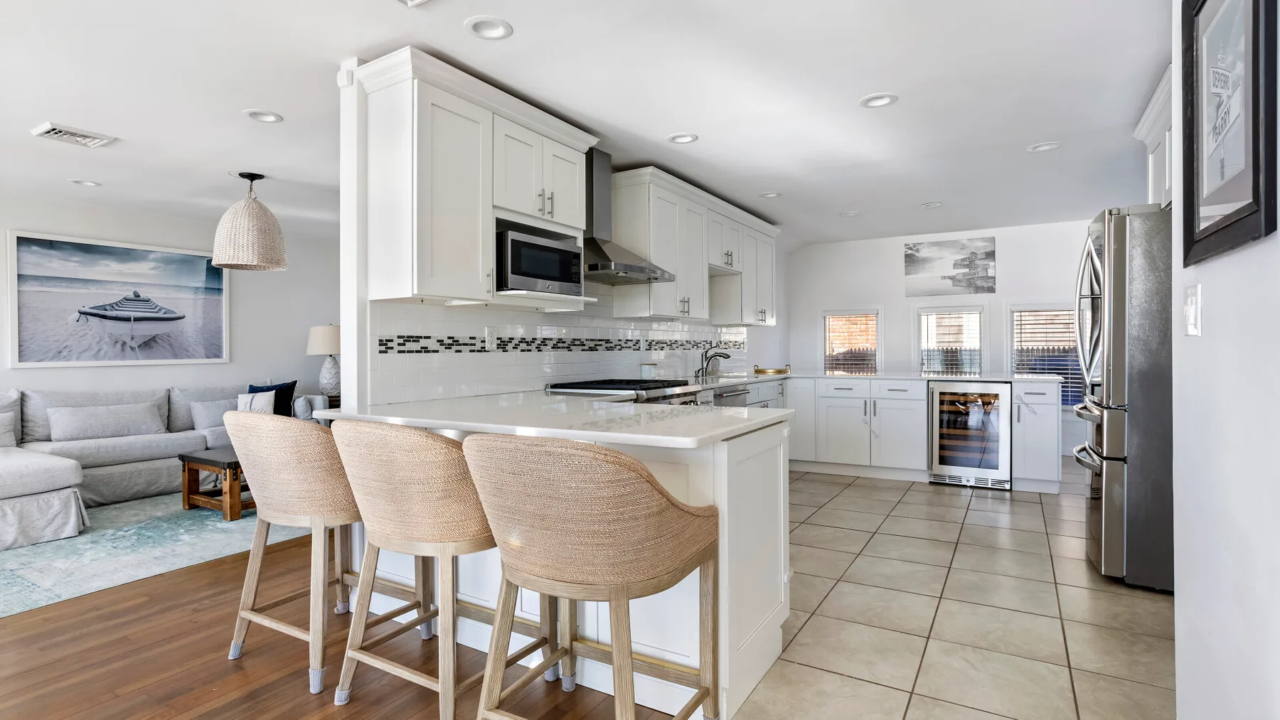 An open-plan kitchen and living area with a breakfast counter and seating.