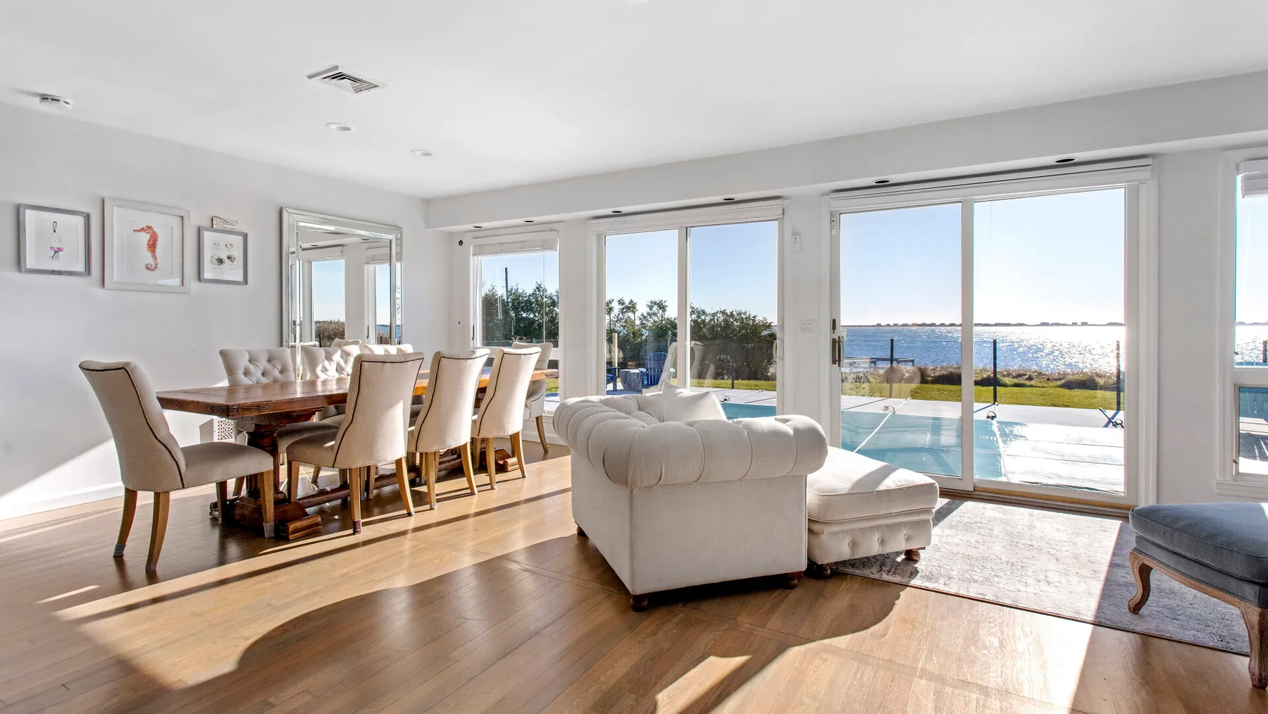 A bright living and dining area opens onto a patio through large glass doors.