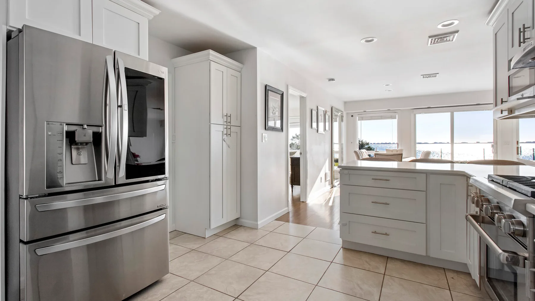 A bright kitchen with stainless steel appliances and a central island.