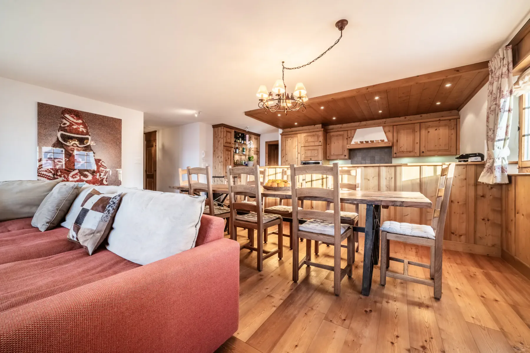 A kitchen with wooden floors and a dining table.
