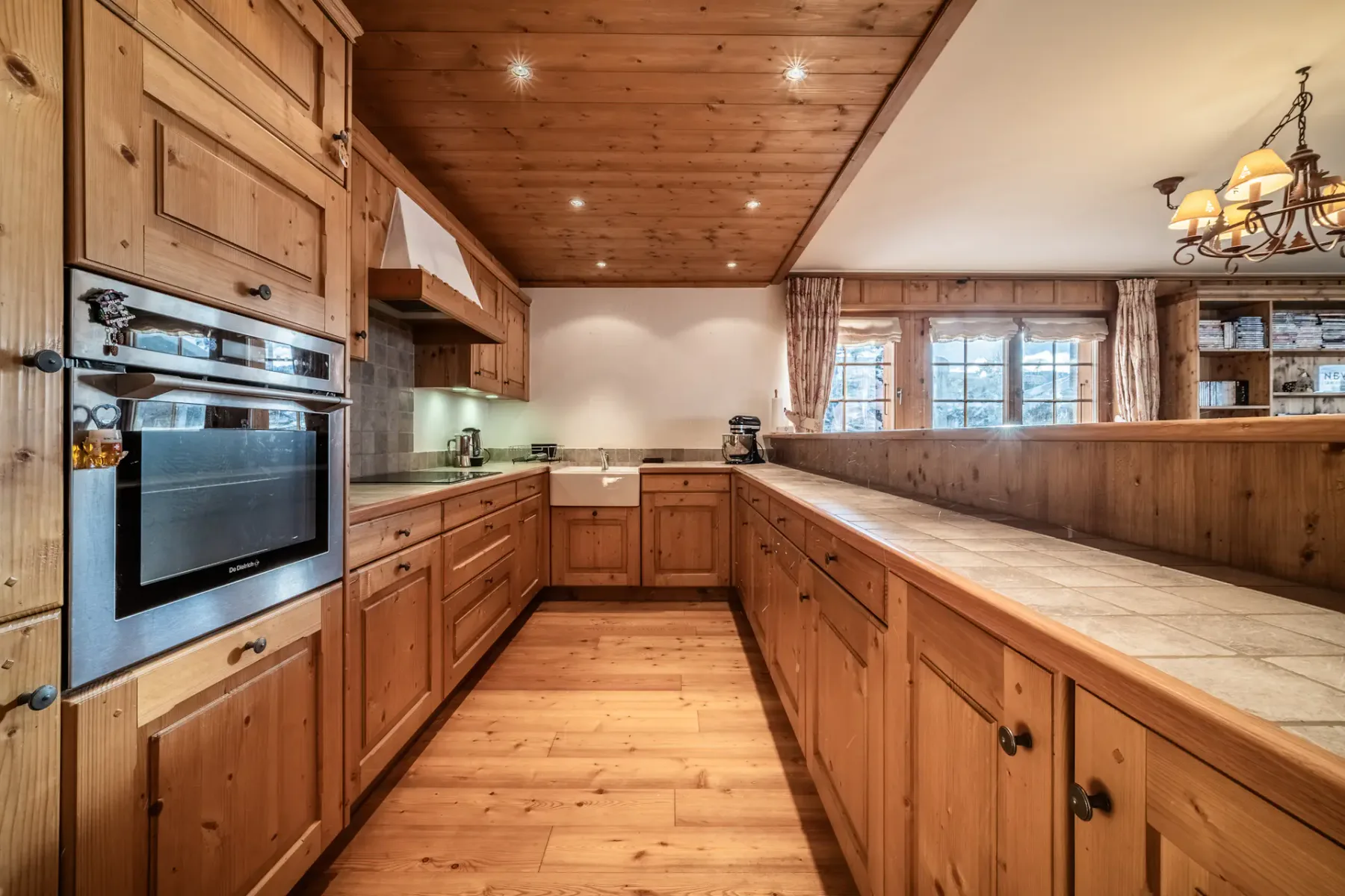 A kitchen with wooden floors and a dining table.