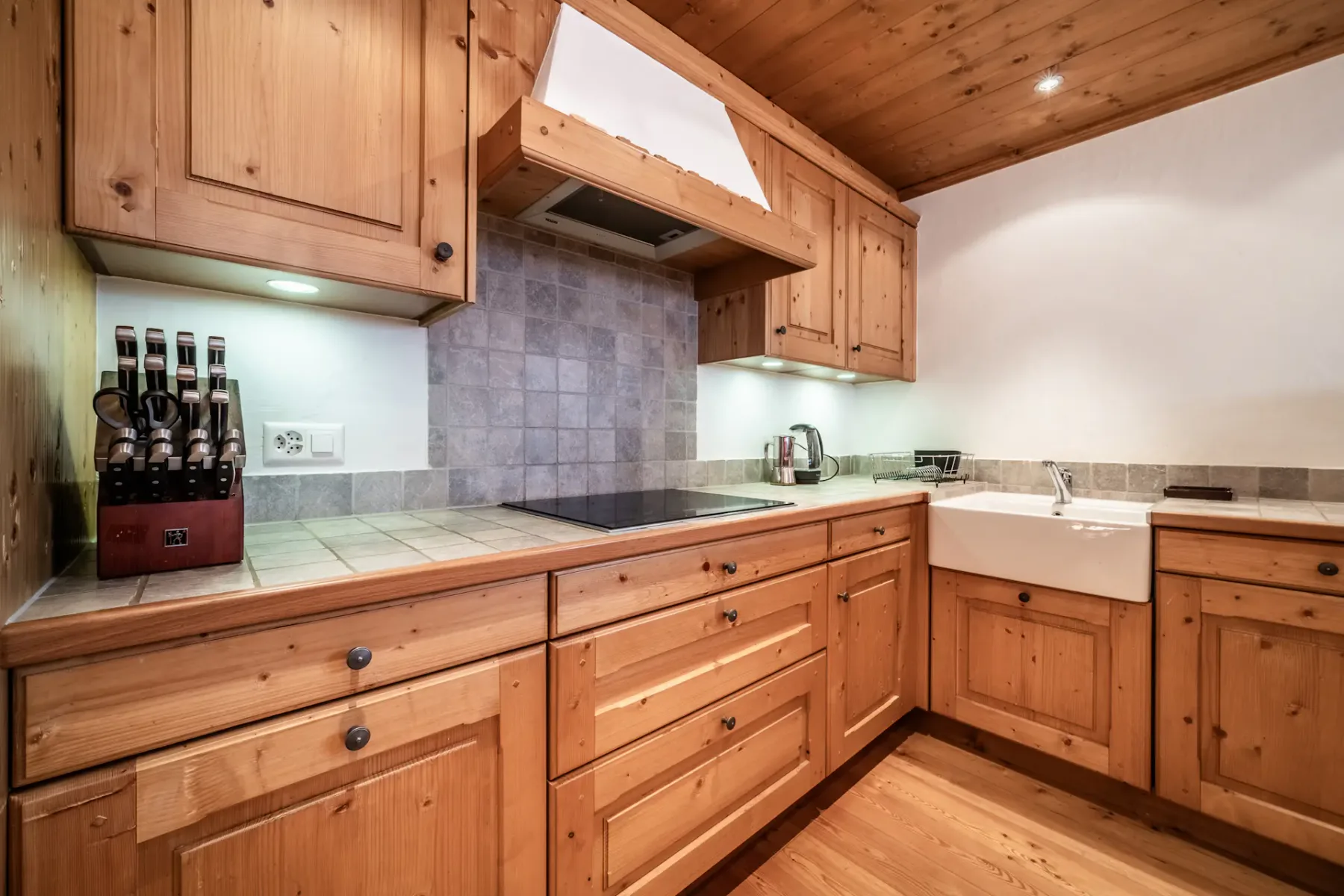A kitchen with wooden floors and a dining table.