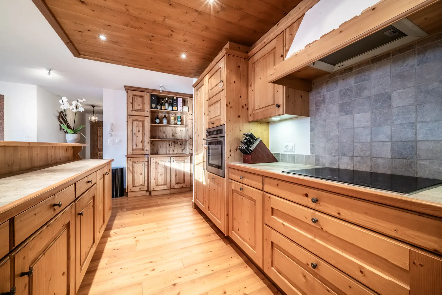 A kitchen with wooden floors and a dining table.