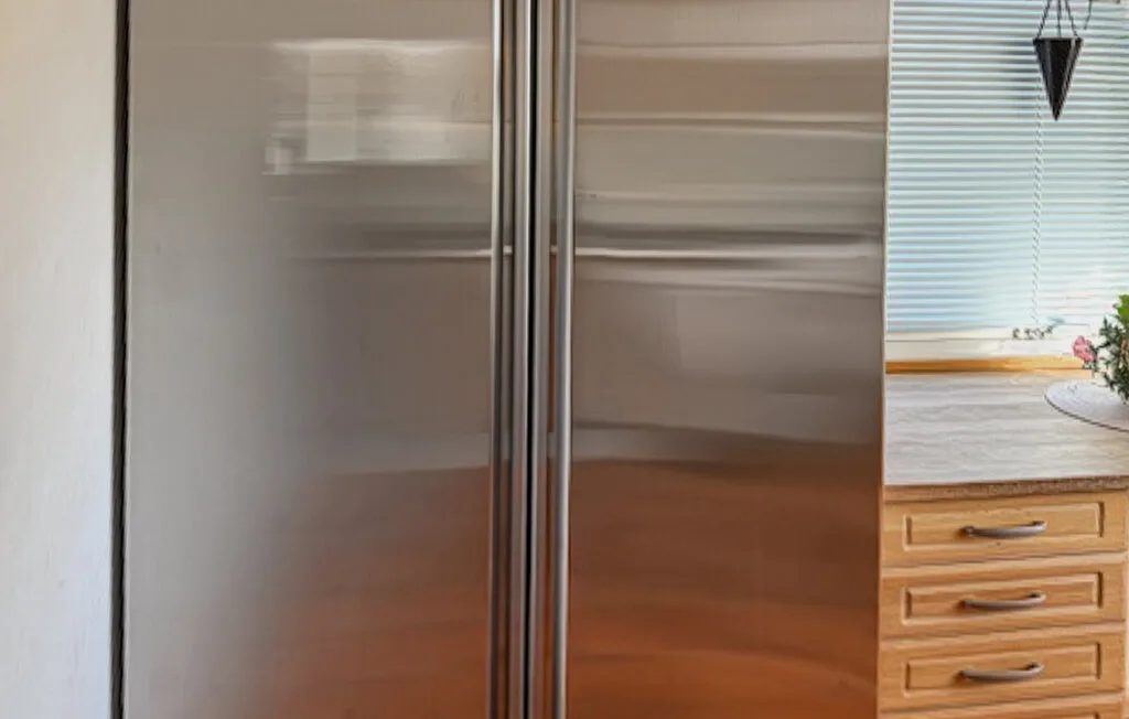 Un dormitorio con un armario grande junto a una cómoda de madera y una ventana.