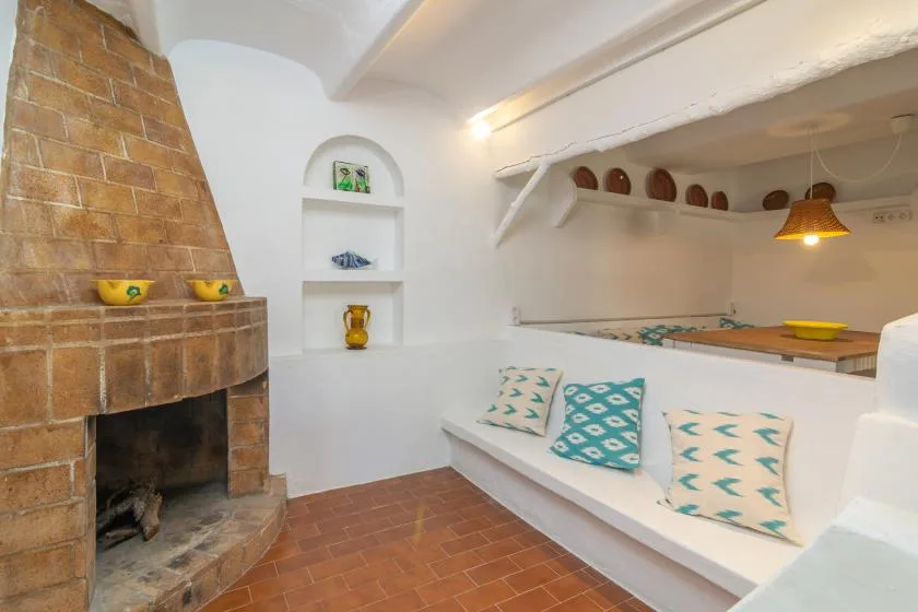 A bright living area with a brick fireplace and built-in seating.