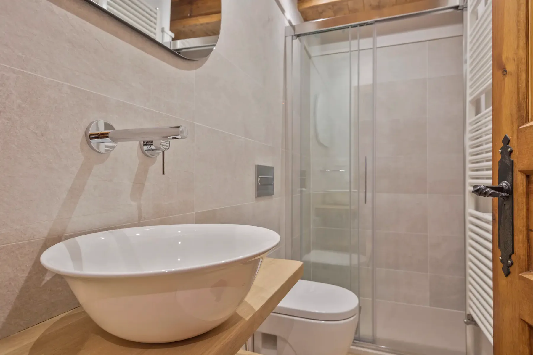 Bathroom with a freestanding bathtub, toilet, and glass shower.