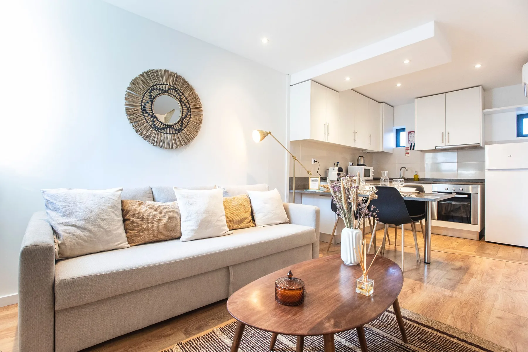 A living room with seating and a dining area beside the kitchen.