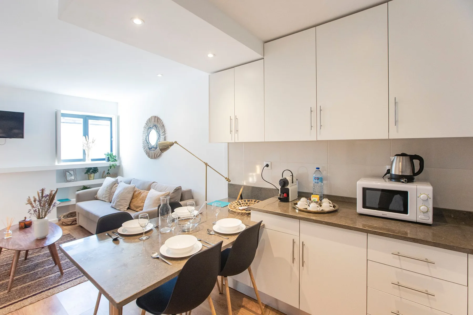 Open-plan living and dining area with a compact kitchen and table.