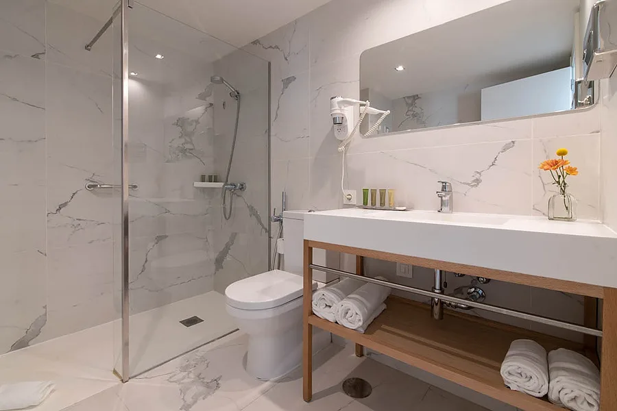 Hotel bathroom with shower and vanity.