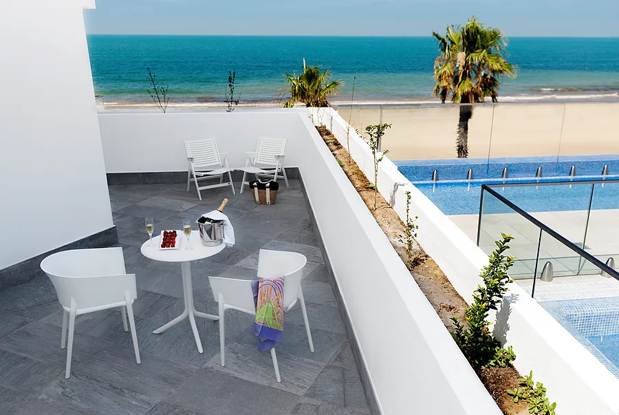 Hotel terrace overlooking the sea and pool.