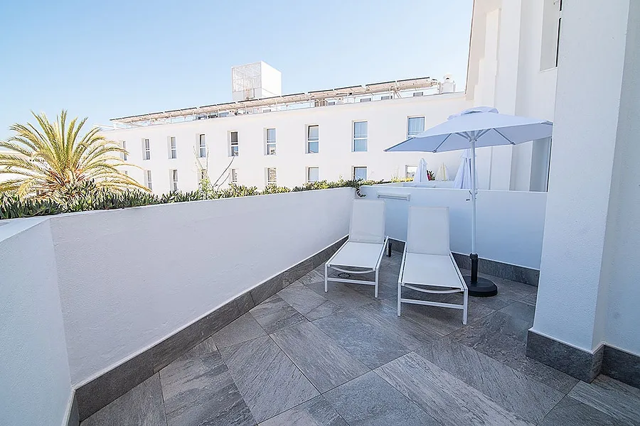 Hotel balcony with loungers.