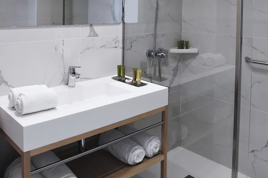Hotel bathroom with shower and vanity.