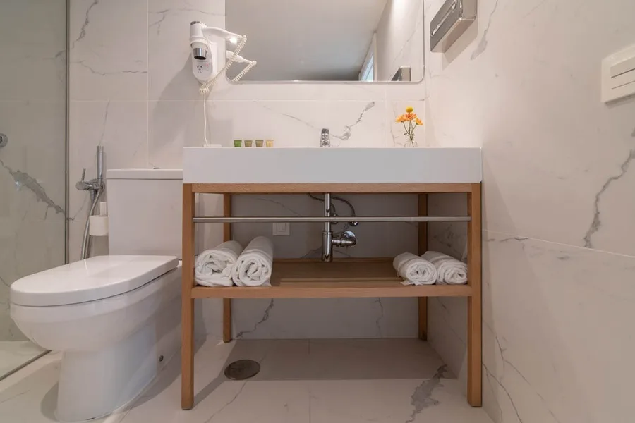 Hotel bathroom with vanity and shower.