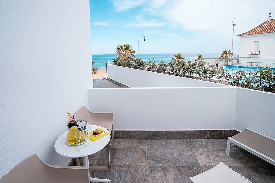Hotel terrace overlooking the beach and pool.