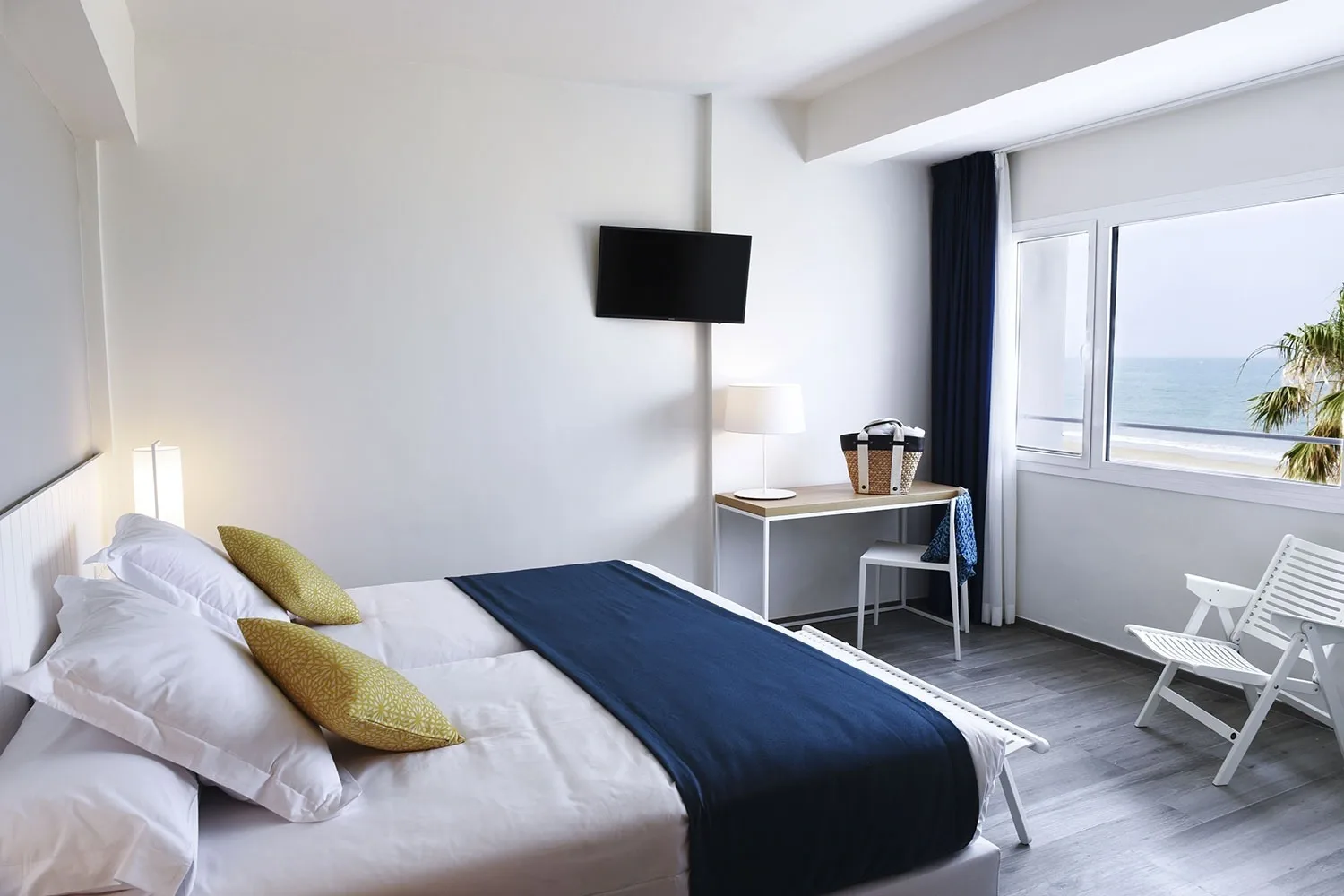 Hotel room with sea views, television and desk.